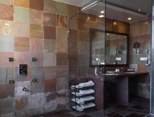 a bathroom with a shower and a sink at hotel sargam sadan in Jāmb