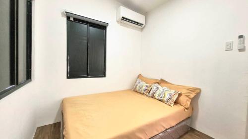 a small room with a couch and a window at Phirst Park Homes Baliwag in Baliuag