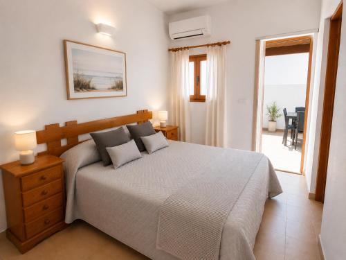 a bedroom with a bed and a view of the ocean at Can Joan Robert des Mestre in Es Caló