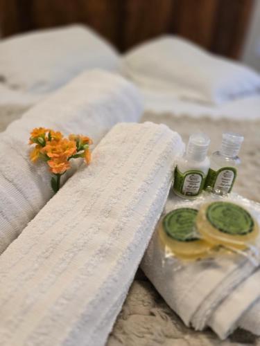 a bed with two towels and two bottles of soap at Casa De Valentina in Tiradentes