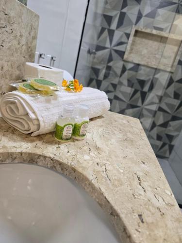 a bathroom with a counter with towels and a sink at Casa De Valentina in Tiradentes