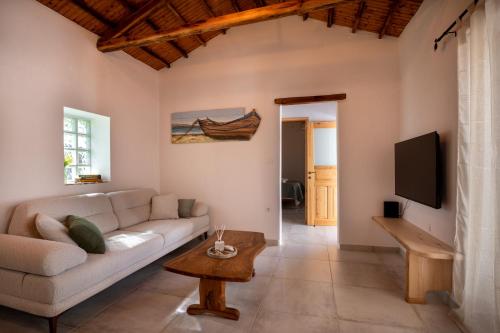 a living room with a couch and a tv at Yiayia's House in Votsi