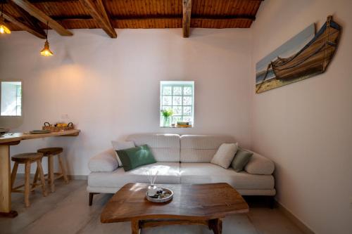 a living room with a couch and a table at Yiayia's House in Votsi