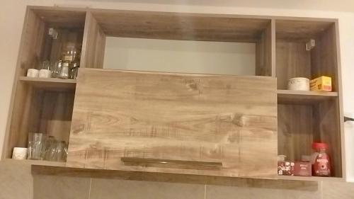 a wooden shelf in a kitchen with bottles and glasses at Avenue Alhambra princess resort in Hurghada