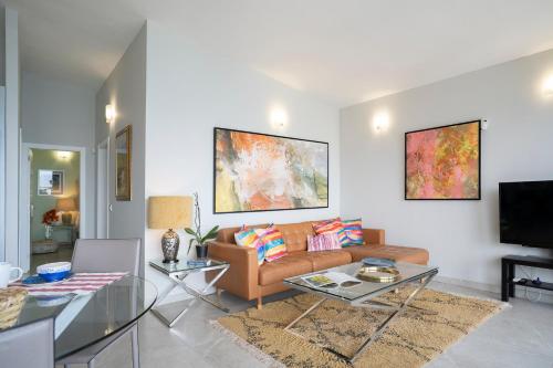 a living room with a couch and a table at In Tenerife, luxury apartment overlooking the Atlantic in Bajamar