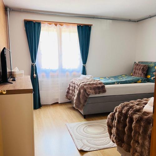 a bedroom with a bed and a window at Chalet Mountain Lodge in Kandersteg