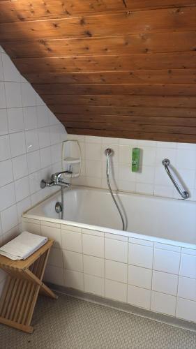 a bathroom with a bath tub with a shower at Gasthaus Hotel Löffelschmiede in Hinterzarten