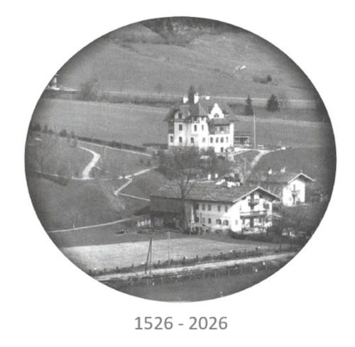 an old black and white photo of a house at Pension Rainhof in Kitzbühel