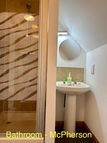 a bathroom with a sink and a mirror at Feochan Portree in Portree