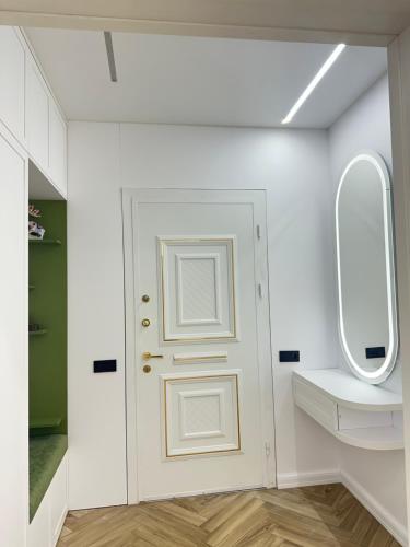 a bathroom with a white door and a mirror at Batumi in Stantsiya Batumi-Passazhirskaya