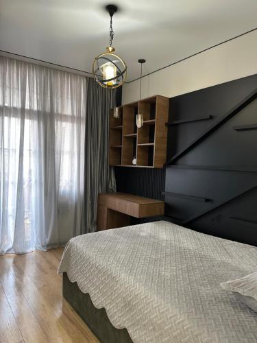 a bedroom with a large bed and a desk at Batumi in Stantsiya Batumi-Passazhirskaya