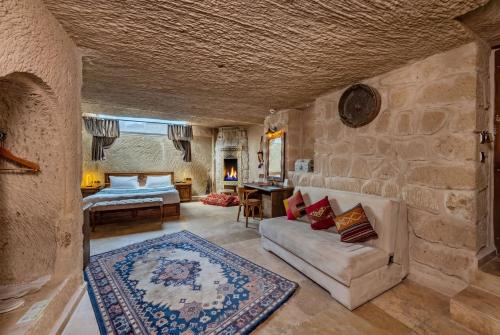 a living room with a couch and a table at Cappa Via Cave Hotel in Ürgüp