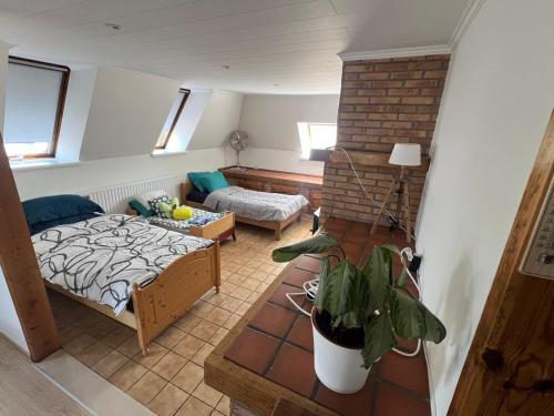 a bedroom with a bed and a living room at Kampenhout appartement met terras en 4 slaap kamers in Kampenhout