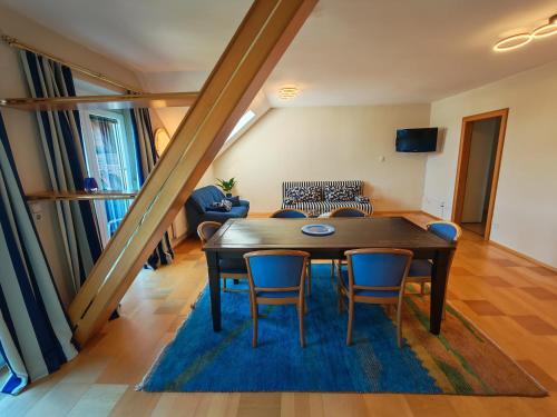 a living room with a table and chairs at Hotel Kärntnerhof Velden - Zum Schankbaron in Velden am Wörthersee