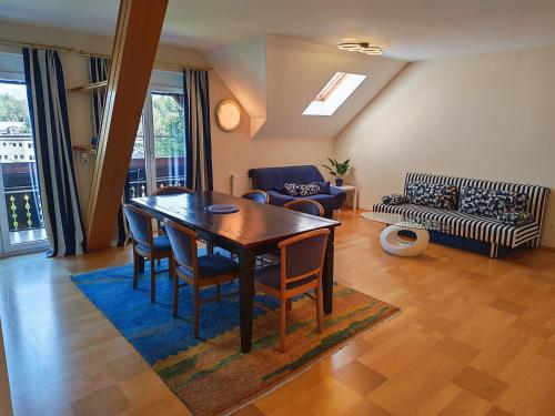 a living room with a table and chairs and a couch at Hotel Kärntnerhof Velden - Zum Schankbaron in Velden am Wörthersee
