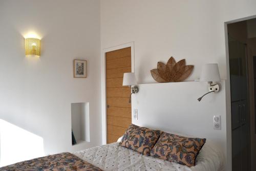 a bedroom with a bed with a flower on the wall at A Casetta d'Armonio in Piana