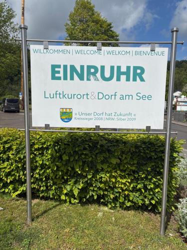 a sign for the entrance to a building at Am Obersee Hotel in Simmerath