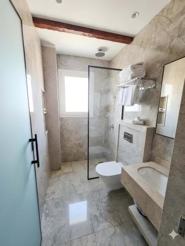 a bathroom with a toilet and a sink and a tub at Pyramids Spiritual Hotel in Cairo