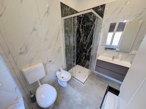 a bathroom with a toilet and a sink and a shower at Monviso in Fossano