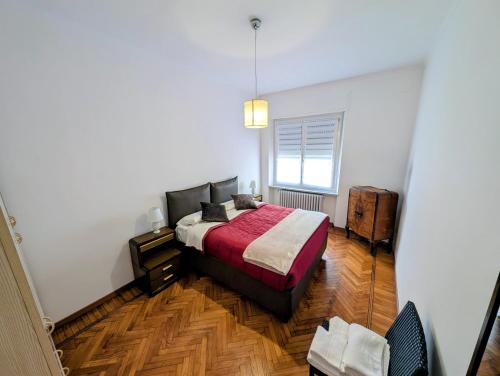 a small bedroom with a bed and a window at Monviso in Fossano