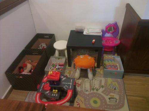 a toy room with a table and toys in boxes at Kyjovský pivovar - hotel, restaurace, pivní lázně in Kyjov