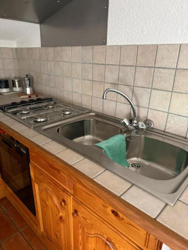 a kitchen with a sink and a stove at La mansarda in Miranda