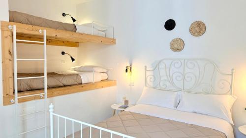 a bedroom with two bunk beds and a crib at Nel Borgo di San Francesco - Ospitalità Diffusa - Relax tra Roccaraso e Costa dei Trabocchi in Villa Santa Maria