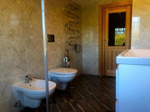 a bathroom with a toilet and a sink at Sunny seaside place in Jūrmala