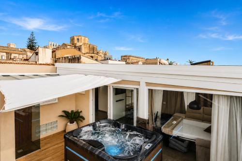 a hot tub on the roof of a house at Saffi Suites in Noto