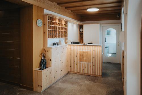 a kitchen with wooden walls and a counter top at Hotel Ludwigshof & Luvina in Trodena