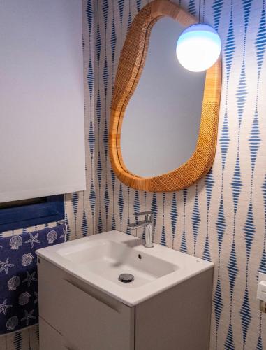 a bathroom with a sink and a mirror at Meloneras in Meloneras
