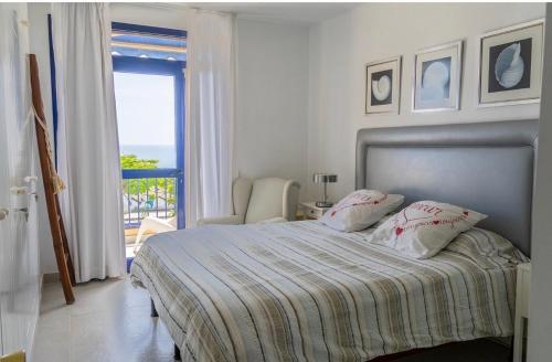 a bedroom with a bed with a view of the ocean at Meloneras in Meloneras