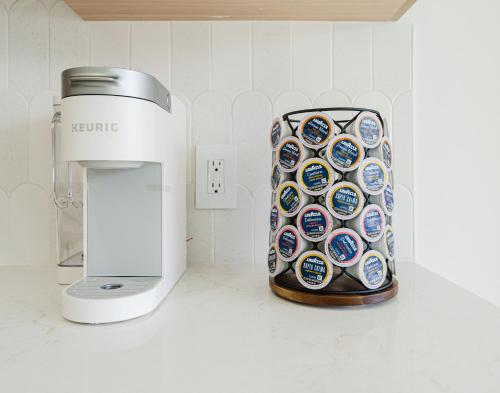 a coffeemaker next to a coffee maker on a counter at Villa Verde - Boca Pool & Beach Walk in Boca Raton