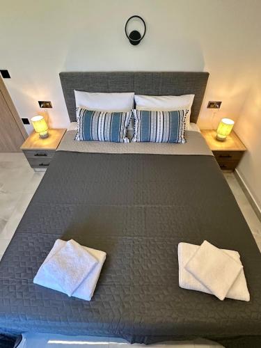 a large bed with two pillows on top of it at Fanari Meltemi Apartment in Fanari