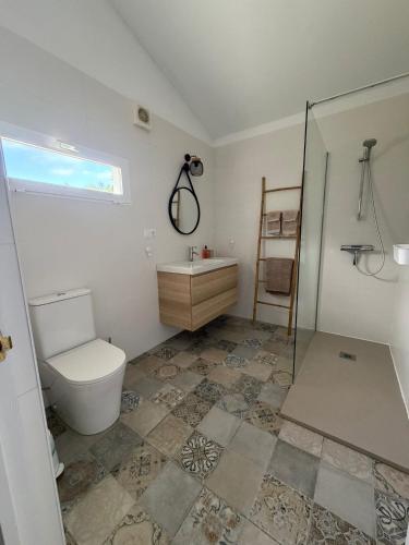 a bathroom with a toilet and a sink and a shower at Casita Malacitano, Caminito del Rey in Valle de Abdalagís
