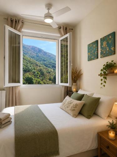 a bedroom with a large bed with a large window at Domaine Saveria in Ponte-Leccia