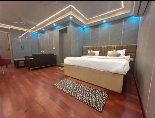 a bedroom with a bed and a desk in a room at Blueberry Premium Hotel in Greater Noida