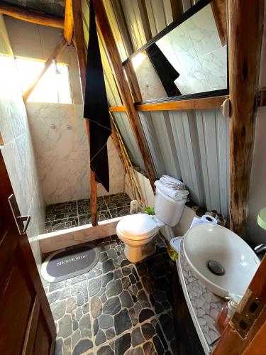 a small bathroom with a toilet and a sink at Awki Wasi - Sacred Valley in Lamay