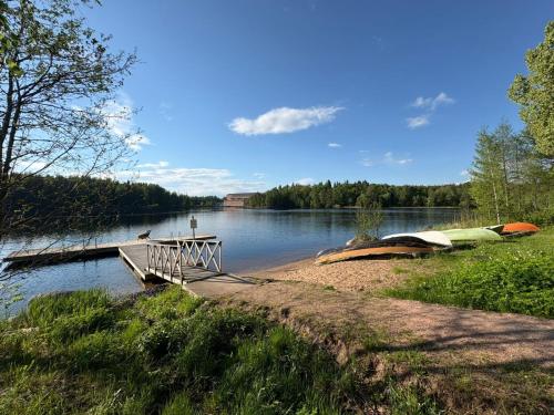 a dock with boats on the shore of a lake at Sun Villa in Imatra
