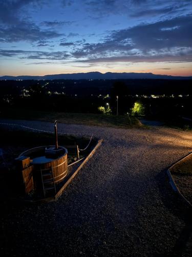 a barrel sitting on top of a hill at sunset at Pensiunea la Tăuț in Călineşti