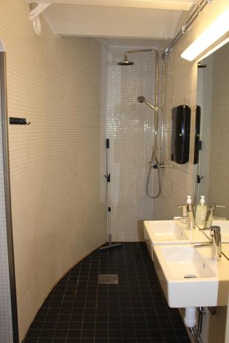 a bathroom with a sink and a shower at Hostel Dalagatan in Stockholm