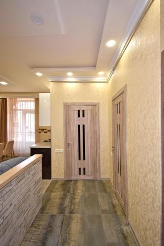 an empty room with a door and a kitchen at Рядом с метро in Yerevan