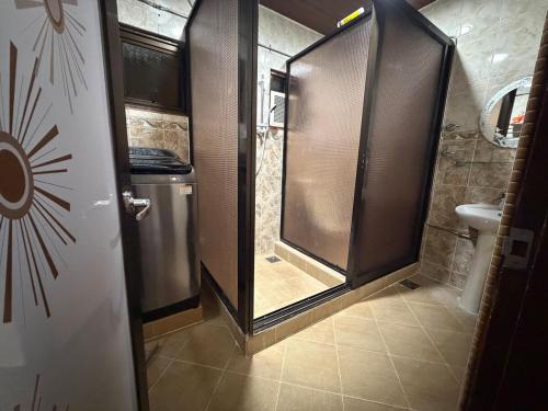 a small bathroom with a shower and a toilet at AmaniStay Cameron Highlands in Cameron Highlands