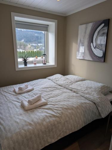 a bedroom with a bed with two towels on it at Leilighet på Voss in Vossevangen