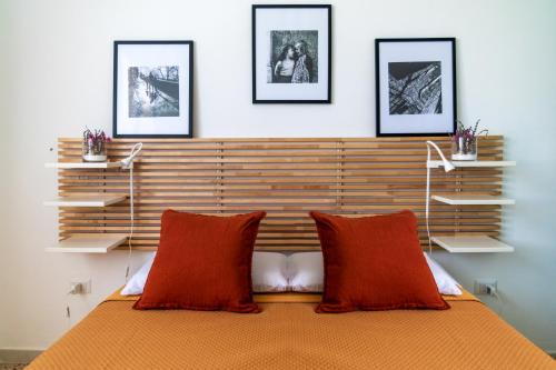 a bedroom with a wooden headboard and red pillows at Cilento Reset in Sapri