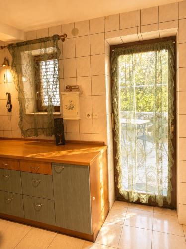 a kitchen with a counter and a window with a table at Sea house Lea in Novi Vinodolski
