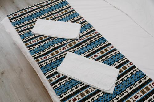 two white boxes sitting on top of a rug at Apple Hostel Bishkek in Bishkek
