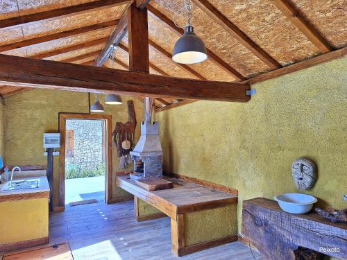 a kitchen with a wooden ceiling with a stove at Casa das Devesas in Caldelas