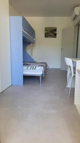 a room with a bed and a table and chairs at Casa Irene in Villasimius