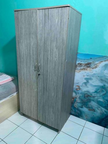 a wooden cabinet sitting on the floor in a room at Wind Stay in Male City